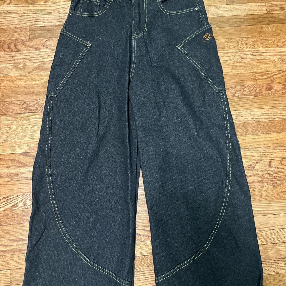 Dark wash baggy barrel jeans with yellow stitching